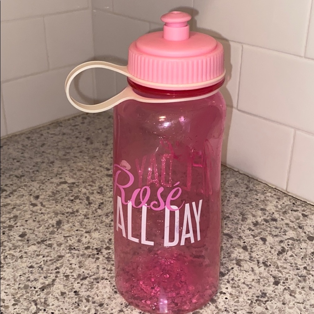 Pink plastic water bottle that says "rose all day"